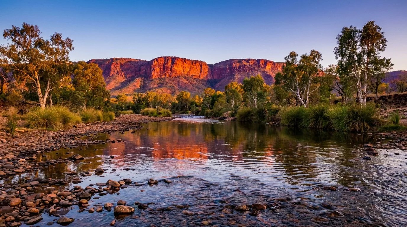 Specktacular landscape view of the Pentecost River crossing and the red sandstone Cockburn Range along the Gibb River Road at sunset golden hour, with zero people or vehicles