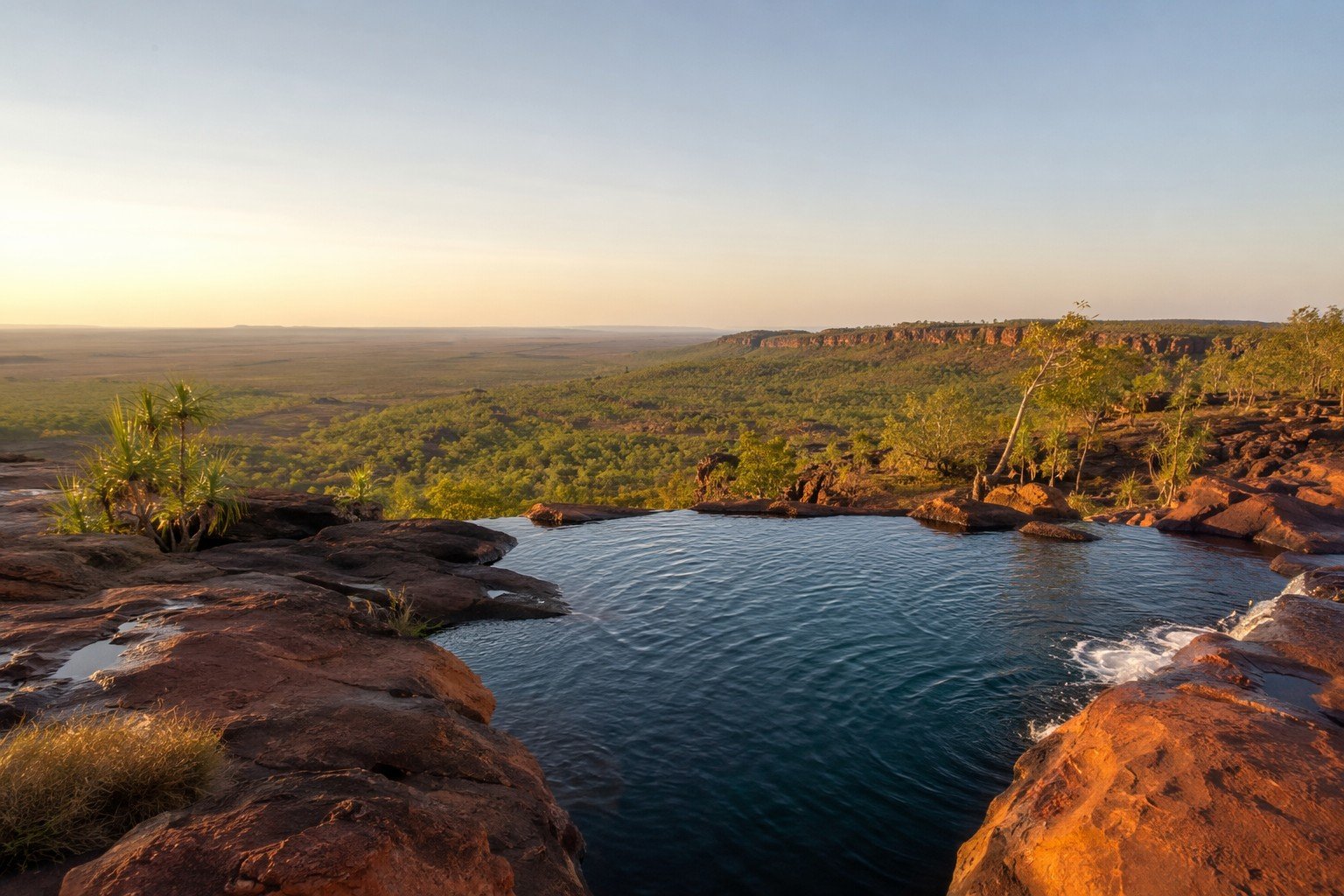 View from the natural infinity pool at the top of Gunlom Falls, Kakadu National Park, at golden hour