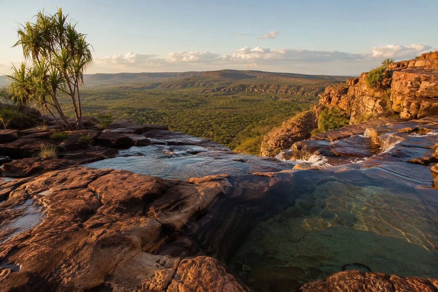View from the natural infinity pool at the top of Gunlom Falls, Kakadu National Park, at golden hour