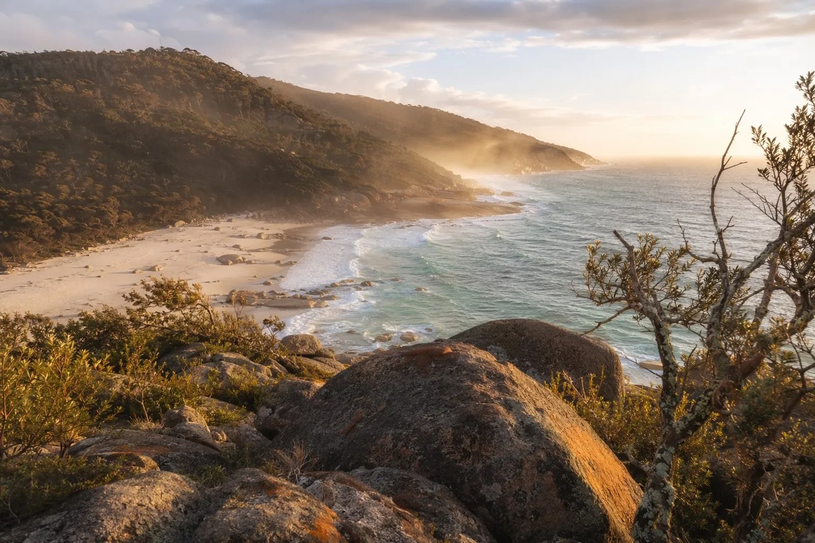 Dramatic granite boulders and white sand beaches of the Wilderness Coast in Croajingolong National Park at sunrise.