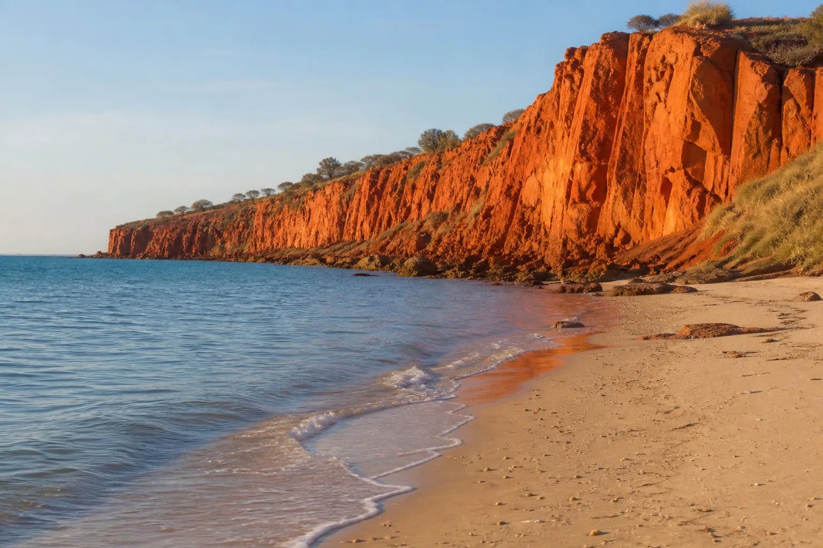 Red pindan cliffs meeting the turquoise Indian Ocean at Cape Leveque, Dampier Peninsula, WA at golden hour.
