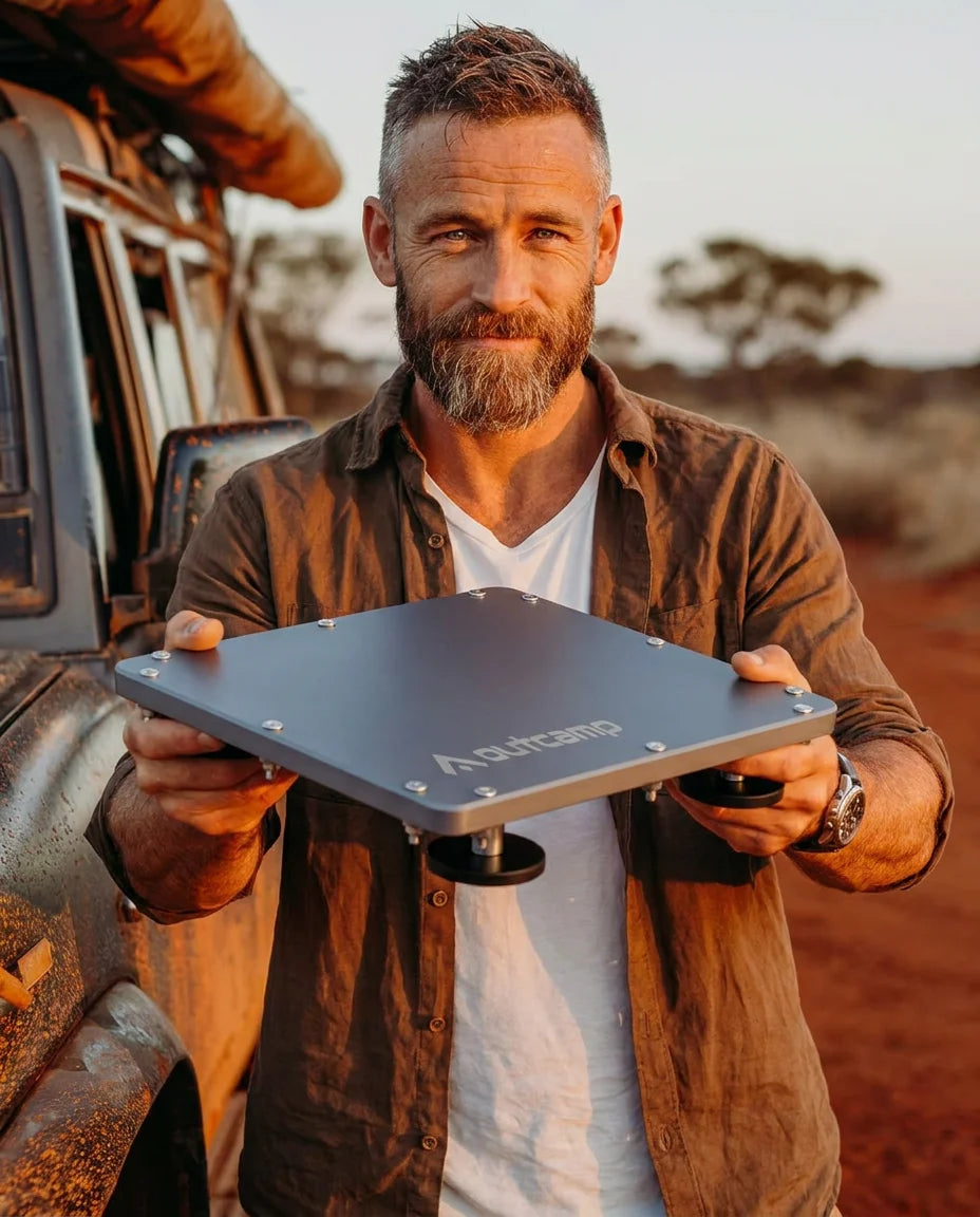 Outcamp brand ambassador holding MagLock Pro Starlink Mini magnetic mount in Australian outback