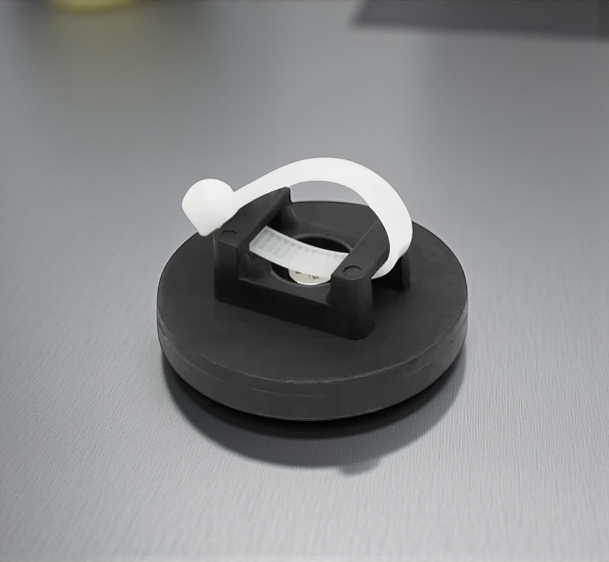 Rubber coated neodymium magnet shown on steel surface close up