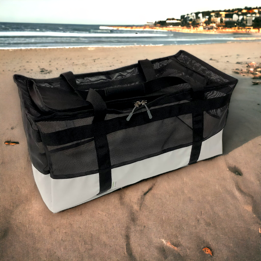 Watersports bag with a backdrop of ocean waves.