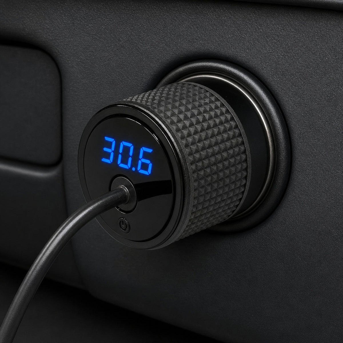 Starlink Mini 12V car adapter plugged into a dashboard socket showing 30.6 volts on the LED readout