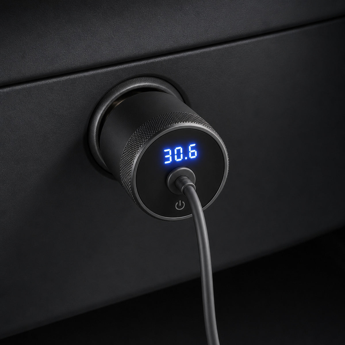 Starlink Mini 12V car adapter plugged into a vehicle accessory socket, LED voltmeter reading 30.6 volts with DC cable connected