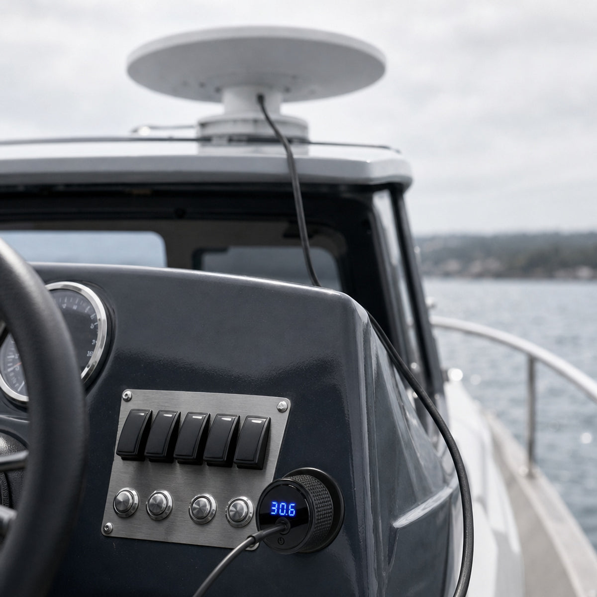 Starlink Mini 12V car adapter plugged into a 12V socket at a boat helm, LED readout showing 30.6 volts