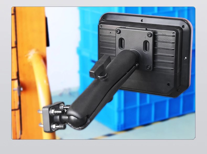 Tablet rear view mounted on U-bolt base in a warehouse setting with blue stock crates in the background